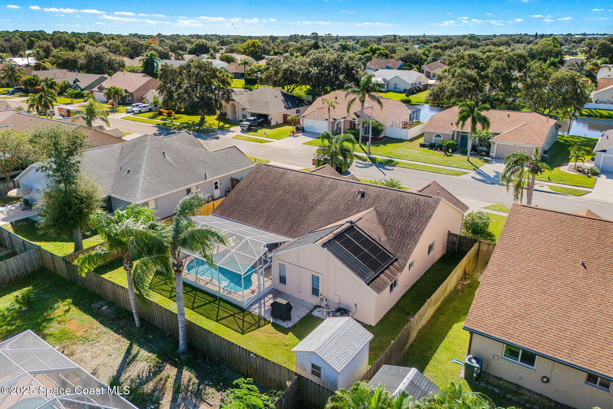 1020 Pelican Lane Rockledge, FL 32955 - Photo 32 of 36 an aerial view of a house with a swimming pool yard and mountain view in back