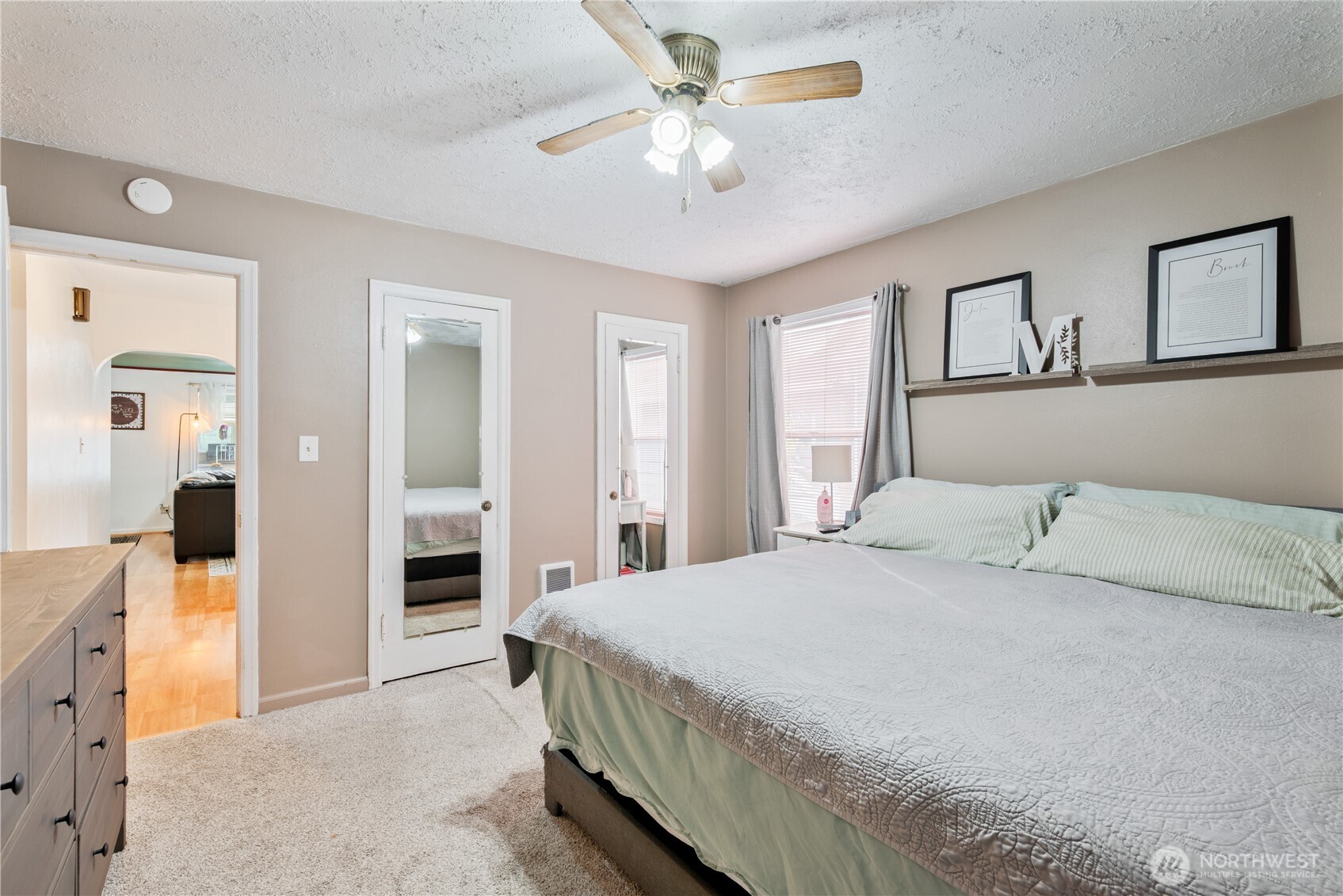 467 19th Avenue Longview, WA 98632 - Photo 14 of 30 a bedroom with a large bed and a chandelier