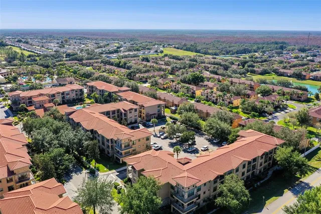 an aerial view of residential houses with outdoor space