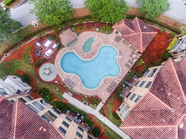 an aerial view of residential houses with outdoor space and trees