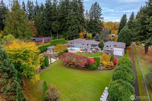 an aerial view of a house with a garden and swimming pool