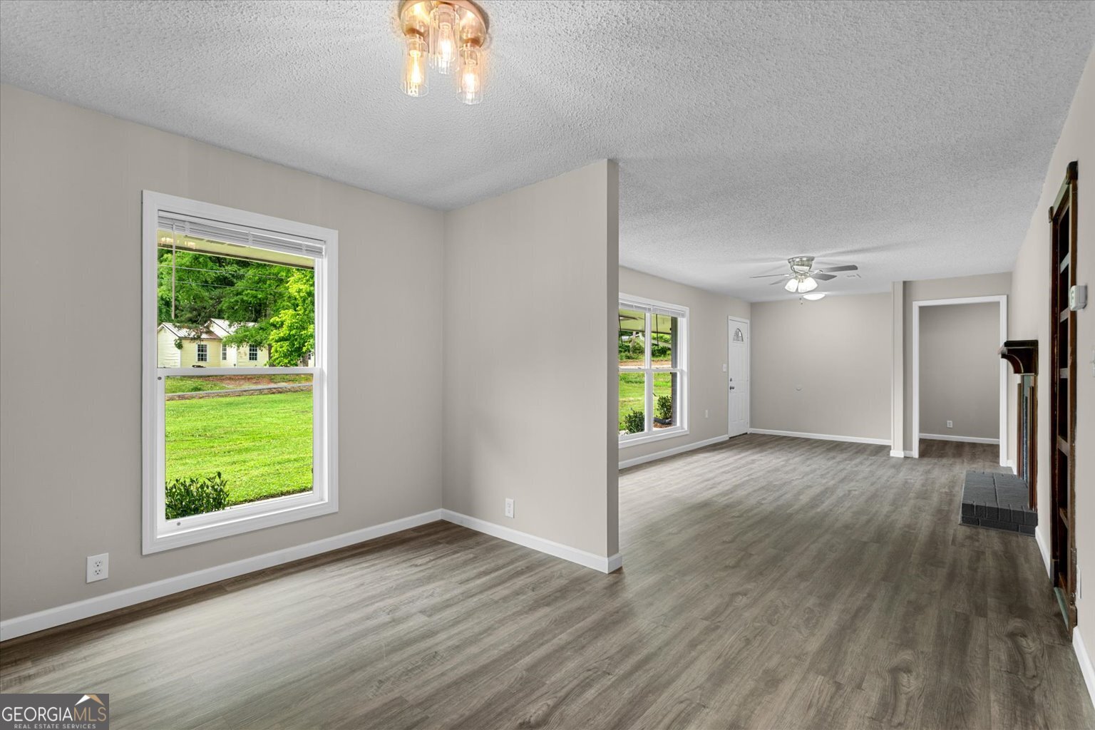 552 Dantzler Circle Dalton, GA 30721 - Photo 11 of 20 a view of an empty room with wooden floor and a window