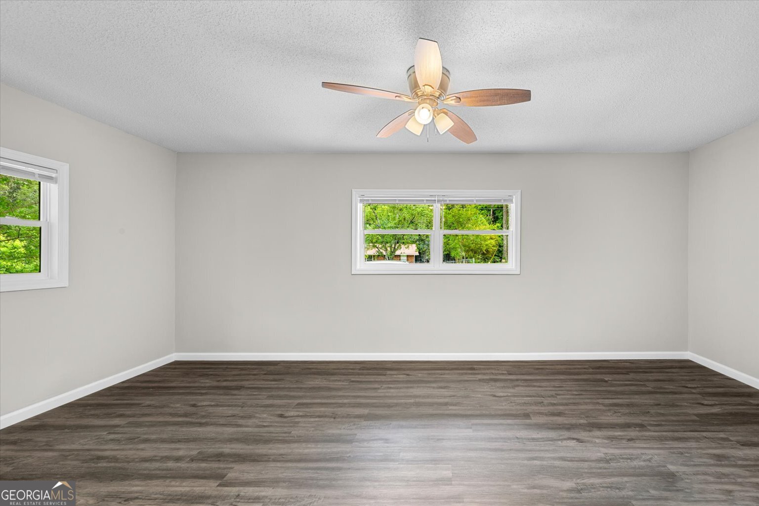552 Dantzler Circle Dalton, GA 30721 - Photo 12 of 20 a view of an empty room with wooden floor and a window