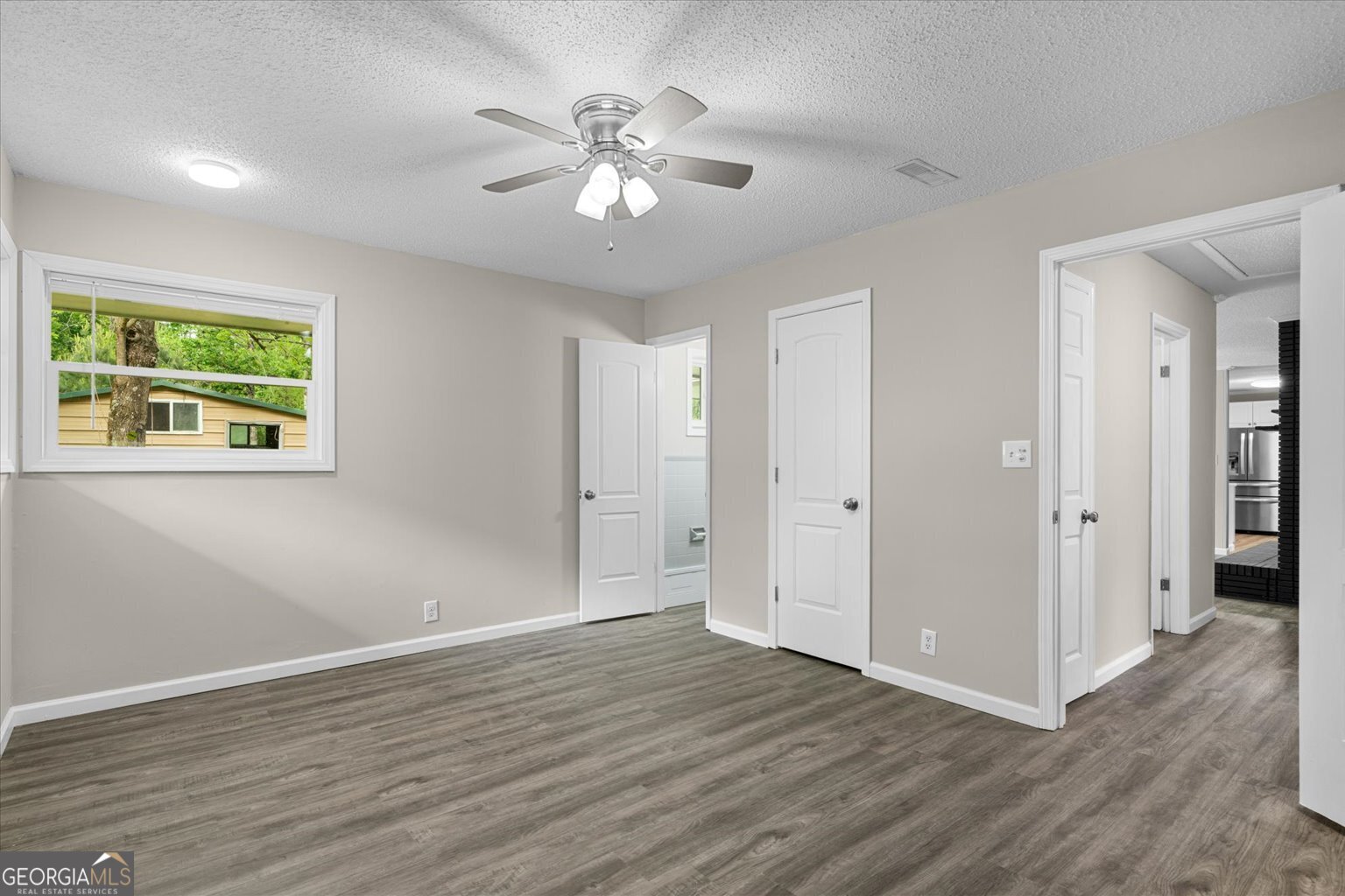 552 Dantzler Circle Dalton, GA 30721 - Photo 14 of 20 a view of an empty room with wooden floor and a window
