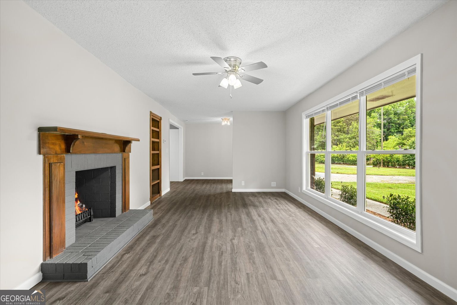 552 Dantzler Circle Dalton, GA 30721 - Photo 4 of 20 a view of an empty room with a fireplace and a window