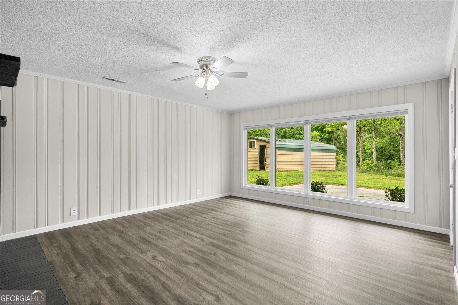 552 Dantzler Circle Dalton, GA 30721 - Photo 8 of 20 a view of an empty room with a window and wooden floor