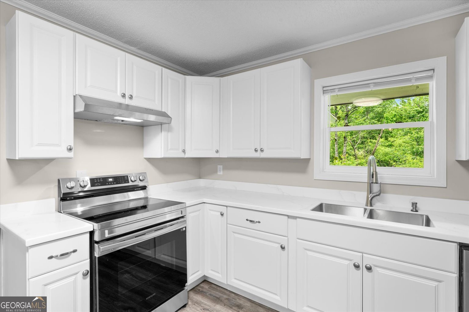 552 Dantzler Circle Dalton, GA 30721 - Photo 9 of 20 a kitchen with white cabinets and appliances