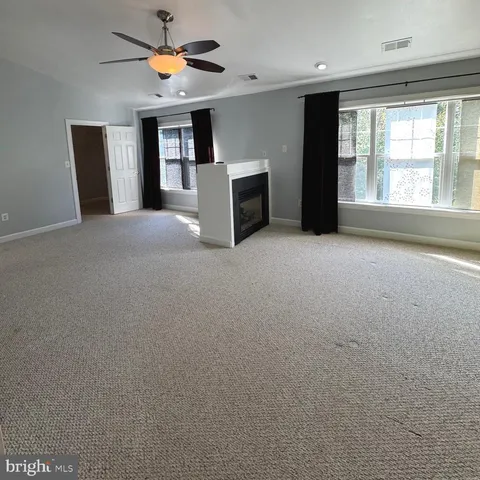 a spacious bathroom with a double vanity sink and mirror