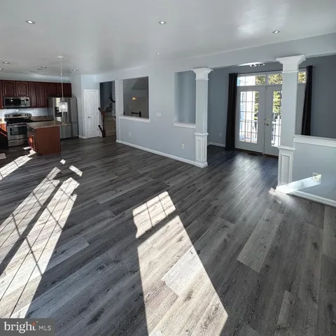 a view of entryway with wooden floor and front door