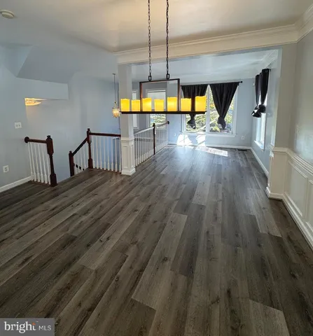 a kitchen with stainless steel appliances granite countertop a stove top oven a sink and a granite counter tops with wooden floors