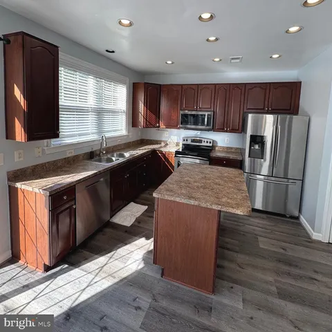 a view of staircase going to a building with metal railing
