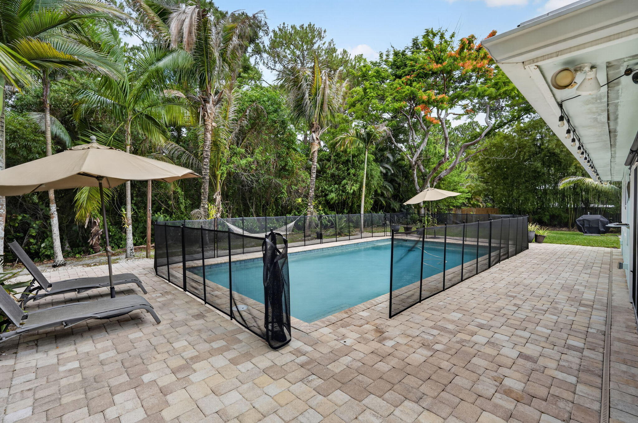 17391 Alexander Run Jupiter, FL 33478 - Photo 33 of 55 a view of a backyard with sitting area and wooden fence