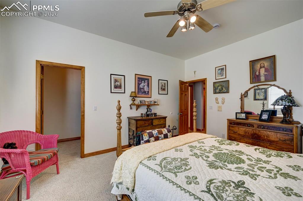 5910 McCart Ranch Circle Elizabeth, CO 80107 - Photo 23 of 50 a bedroom with a bed and a chandelier