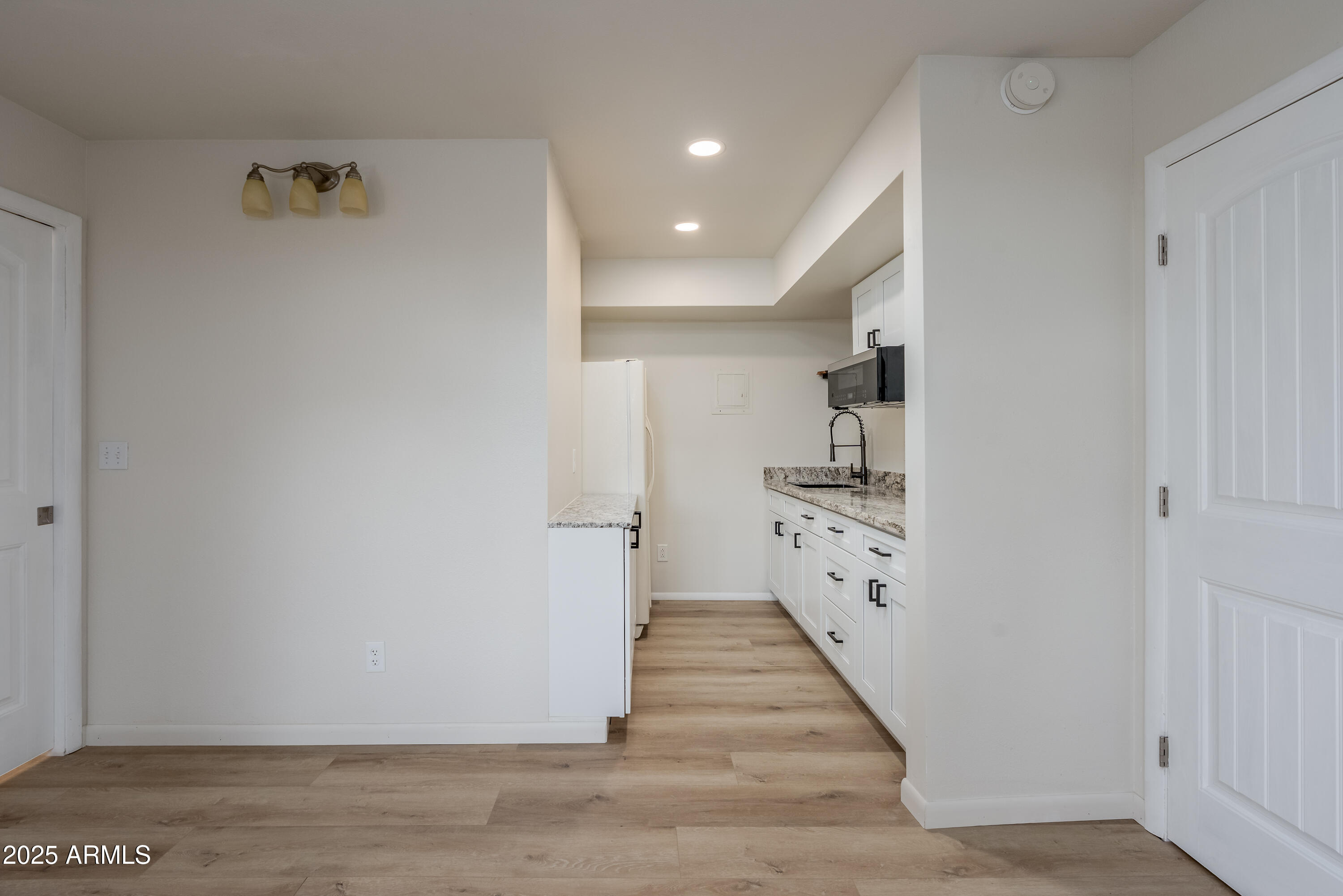 1050 Lee Mountain Road Sedona, AZ 86351 - Photo 31 of 78 a view of a hallway with wooden floor and staircase