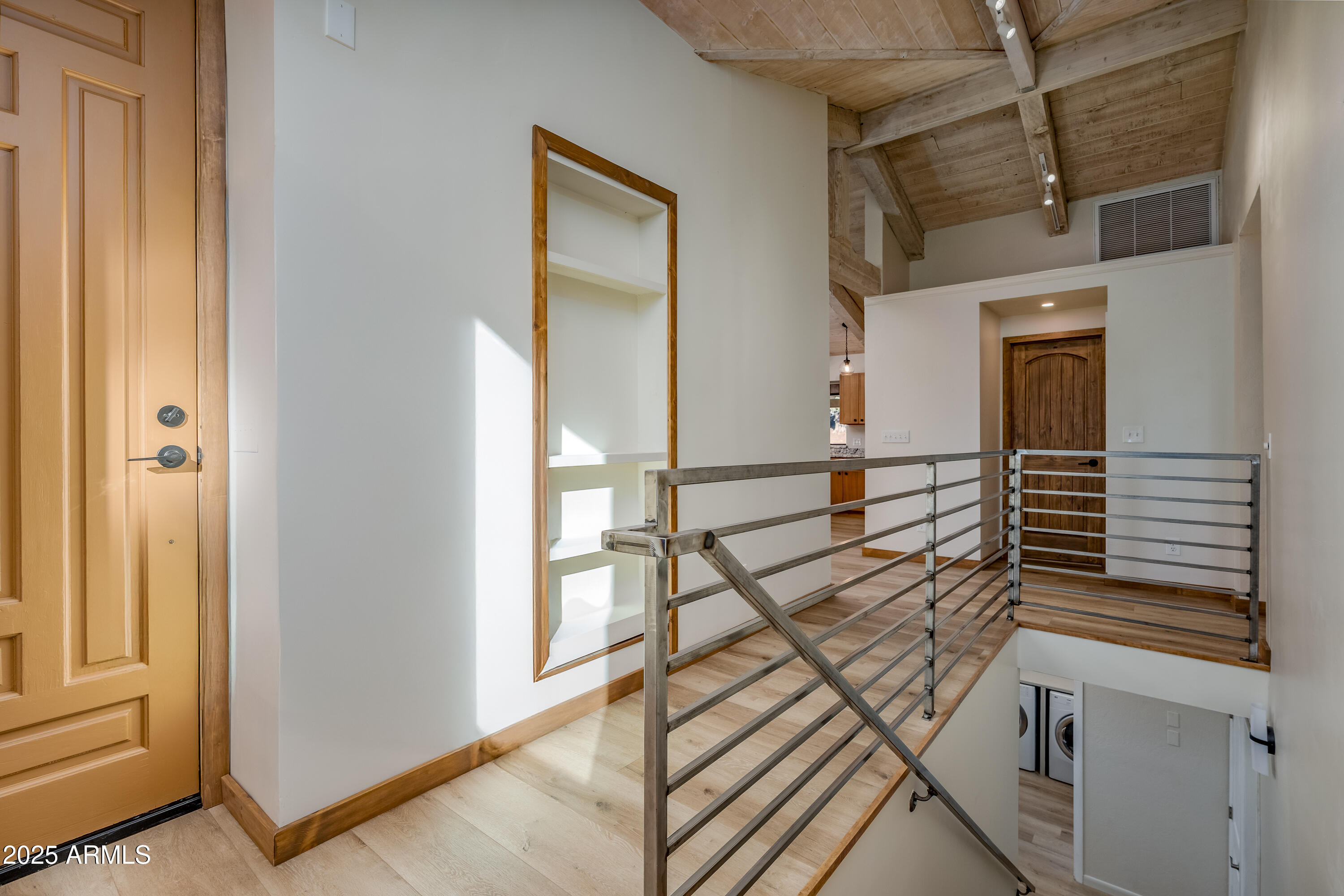 1050 Lee Mountain Road Sedona, AZ 86351 - Photo 32 of 80 a view of a hallway with wooden floor and staircase