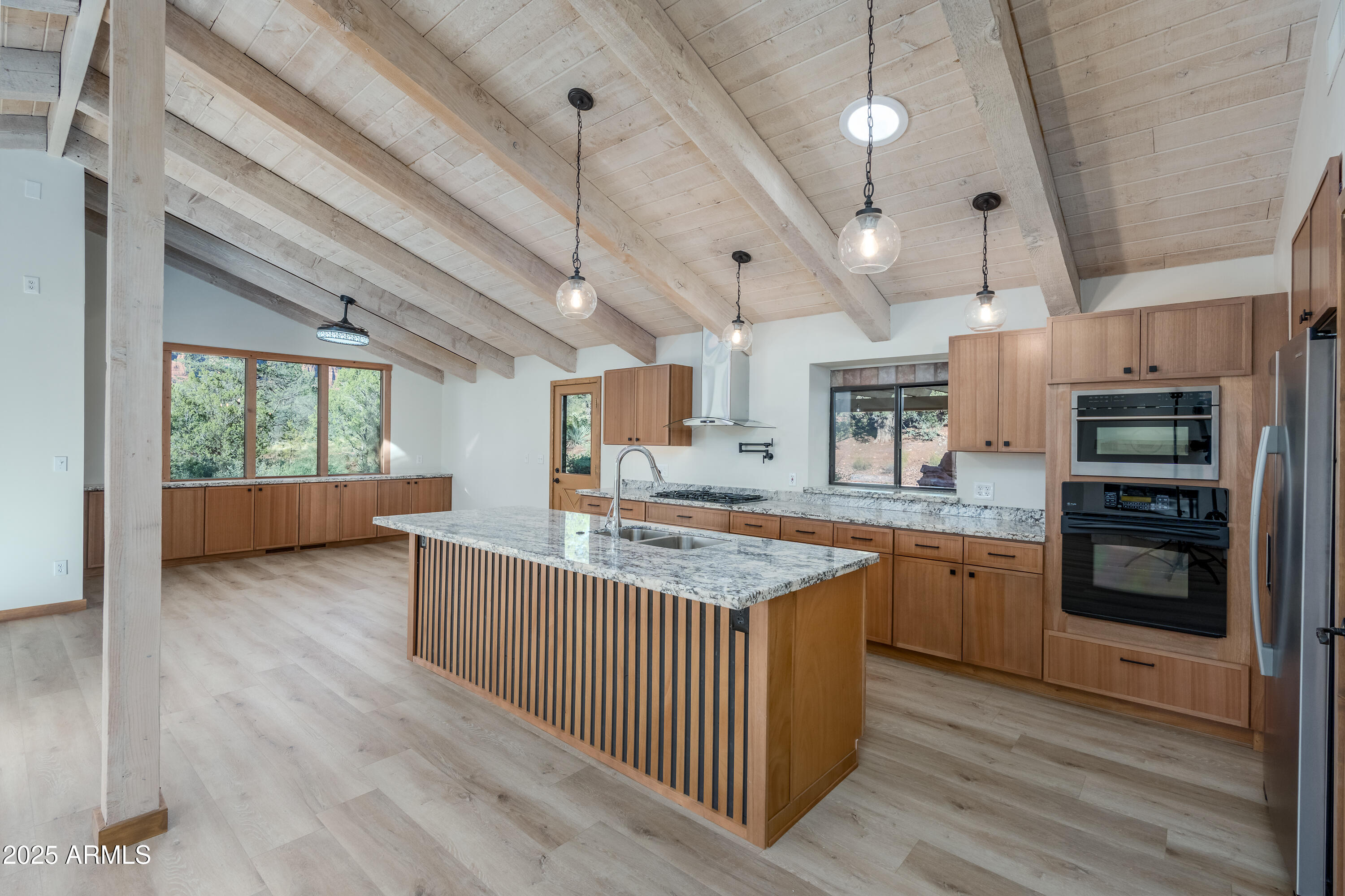 1050 Lee Mountain Road Sedona, AZ 86351 - Photo 33 of 80 a kitchen with stainless steel appliances granite countertop a lot of counter space and wooden floors