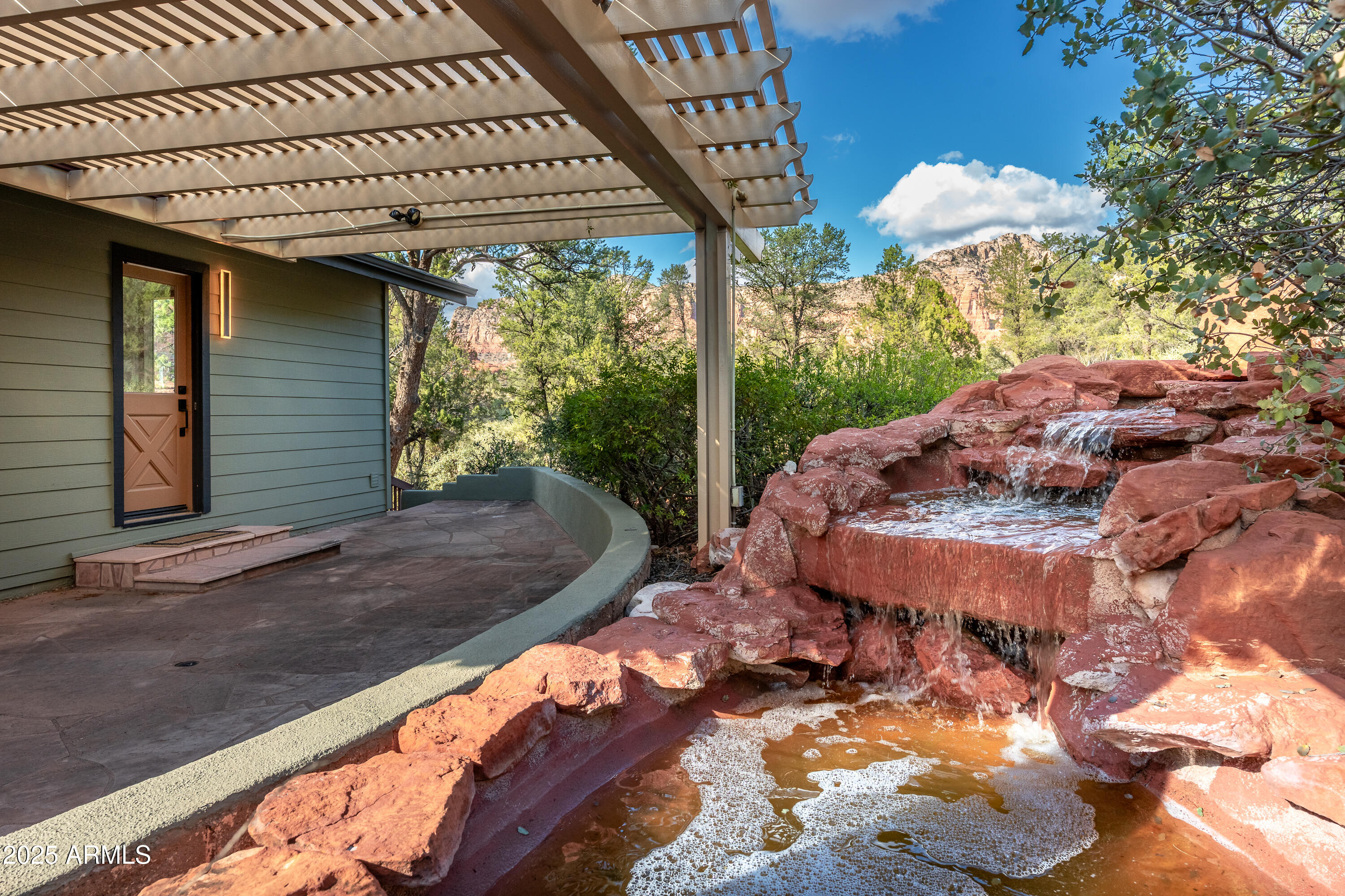 1050 Lee Mountain Road Sedona, AZ 86351 - Photo 52 of 78 a view of a backyard with a large tree