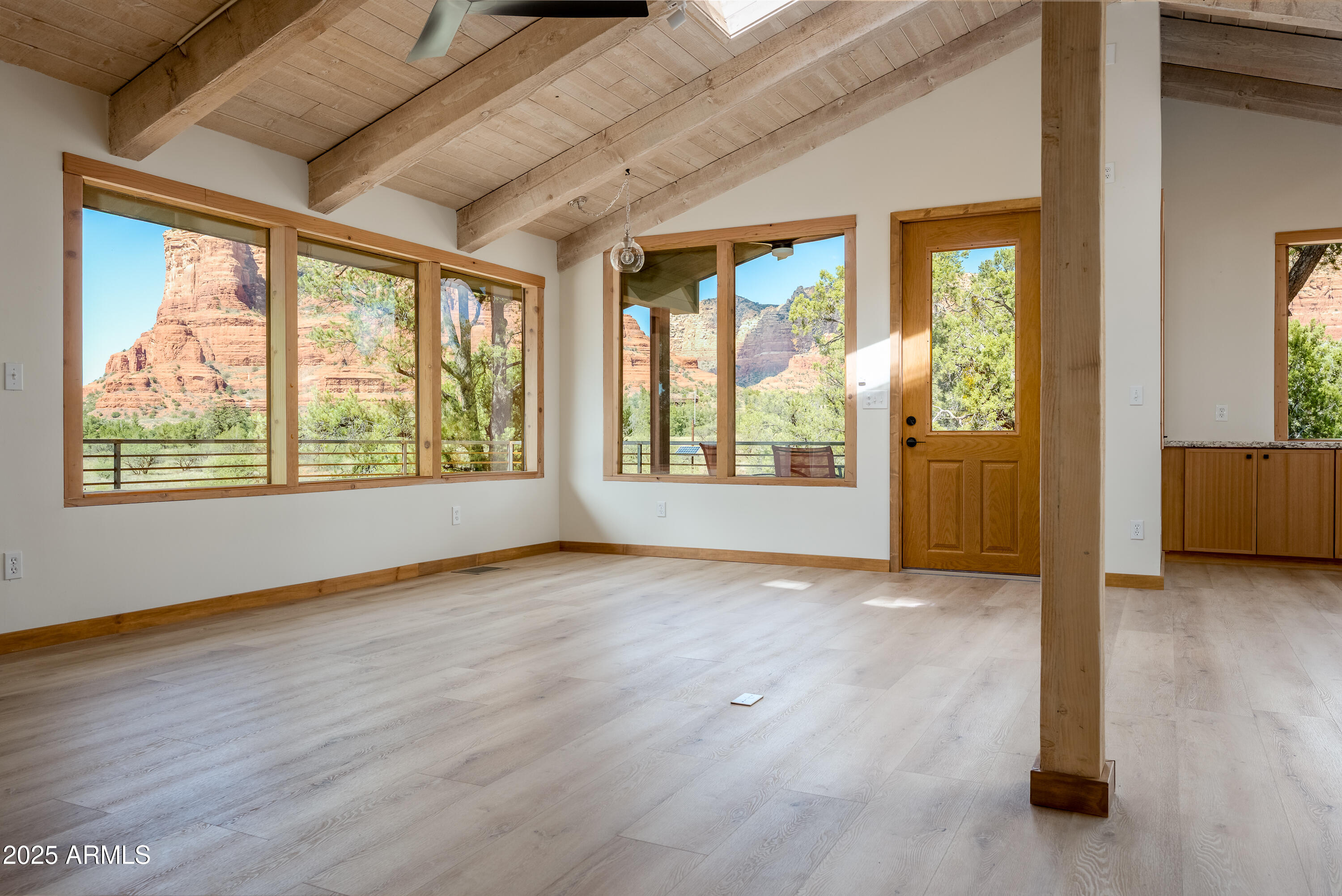 1050 Lee Mountain Road Sedona, AZ 86351 - Photo 57 of 78 an empty room with wooden floor and windows