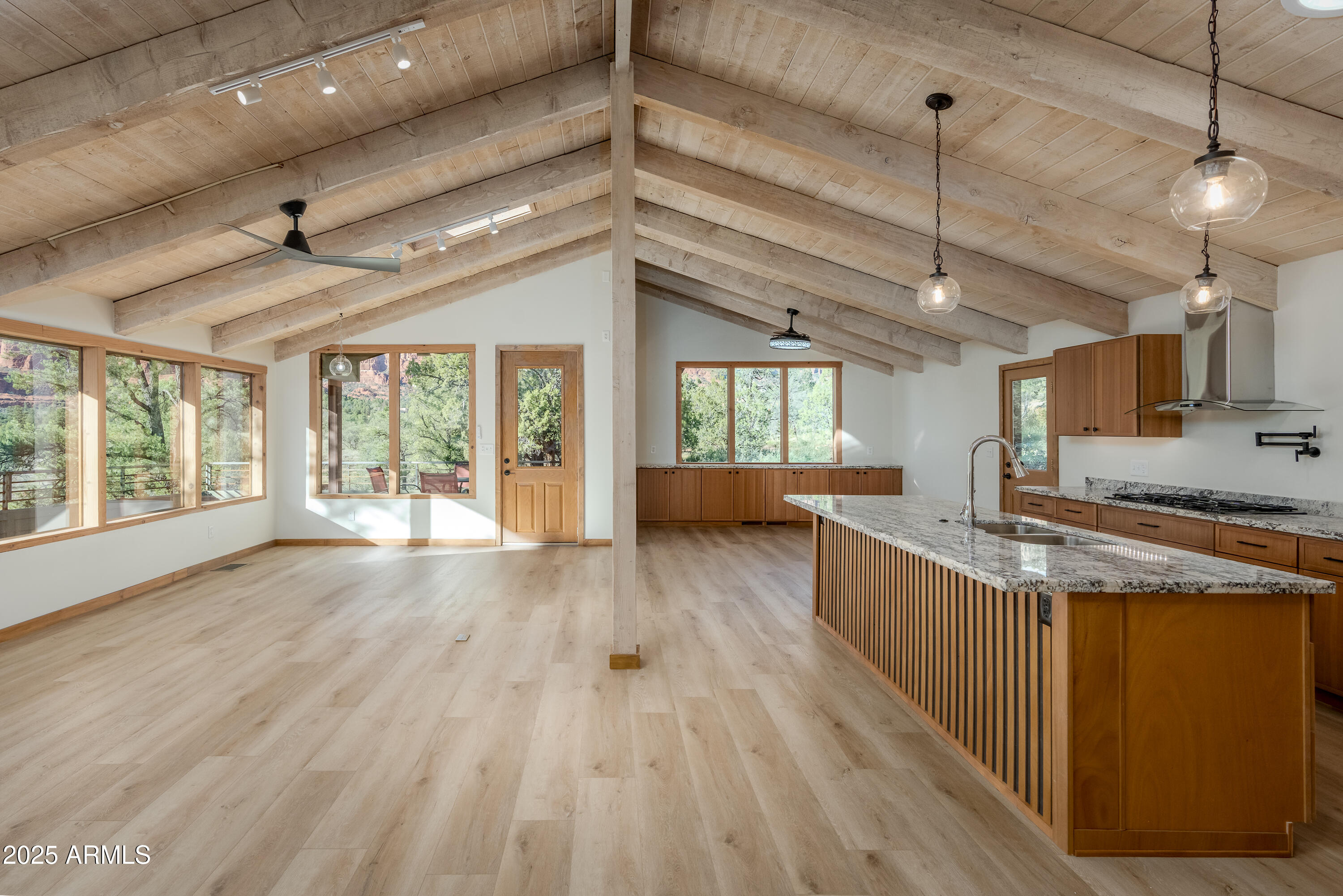 1050 Lee Mountain Road Sedona, AZ 86351 - Photo 63 of 78 a kitchen with stainless steel appliances granite countertop a stove and wooden floors