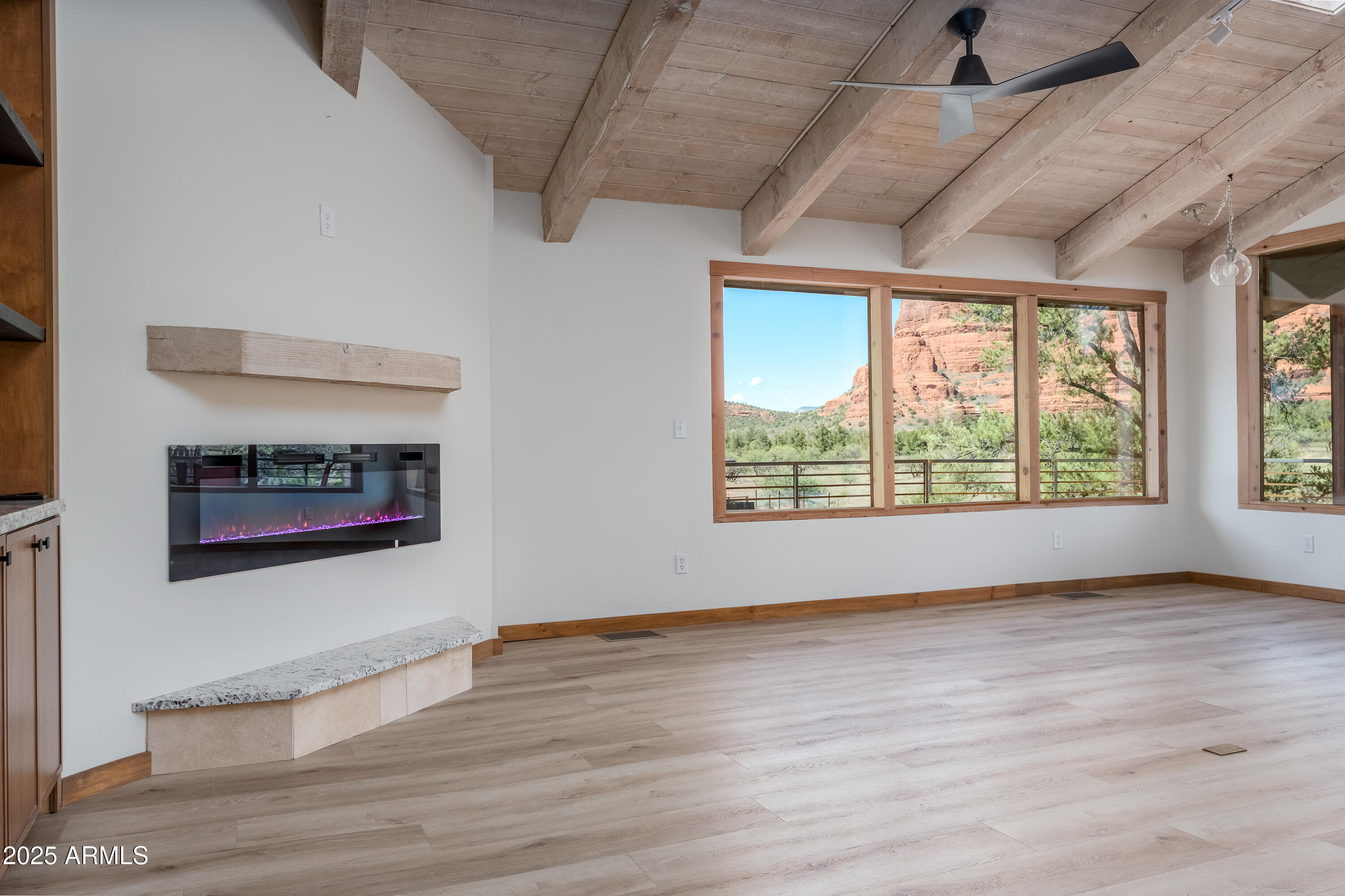 1050 Lee Mountain Road Sedona, AZ 86351 - Photo 64 of 78 a view of an empty room with a window and wooden floor