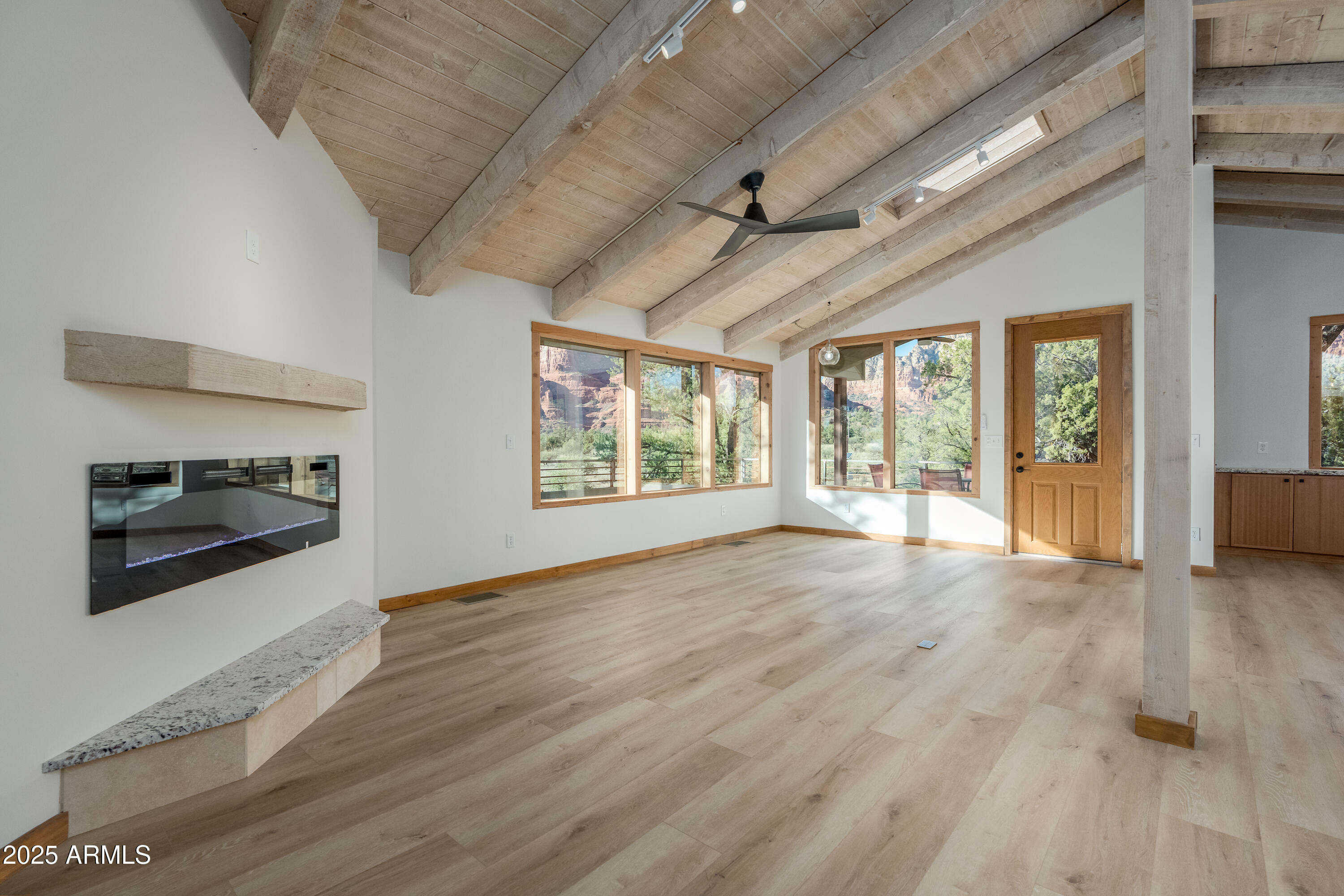 1050 Lee Mountain Road Sedona, AZ 86351 - Photo 66 of 78 a view of an empty room with a window and wooden floor