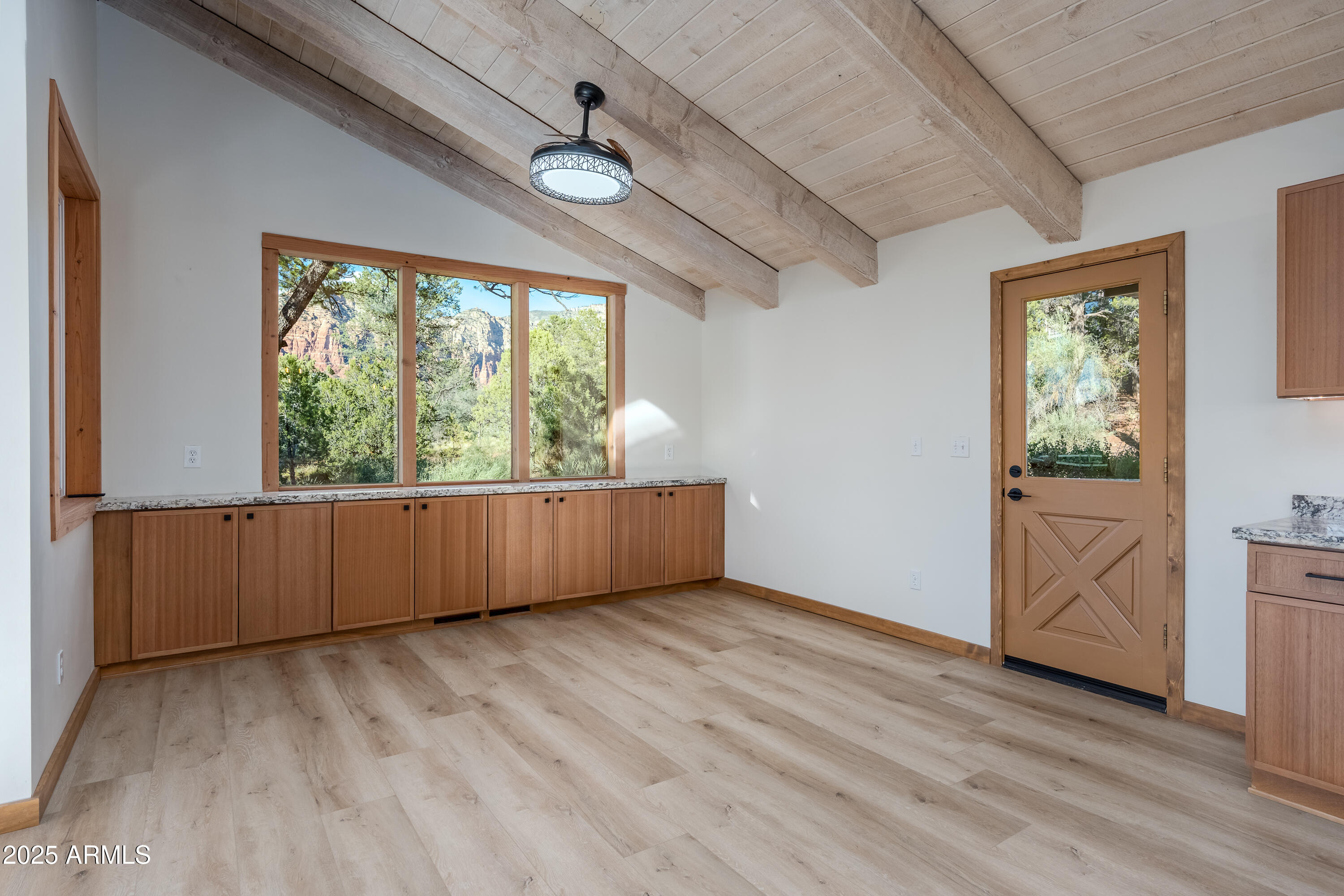 1050 Lee Mountain Road Sedona, AZ 86351 - Photo 69 of 78 an empty room with wooden floor and windows