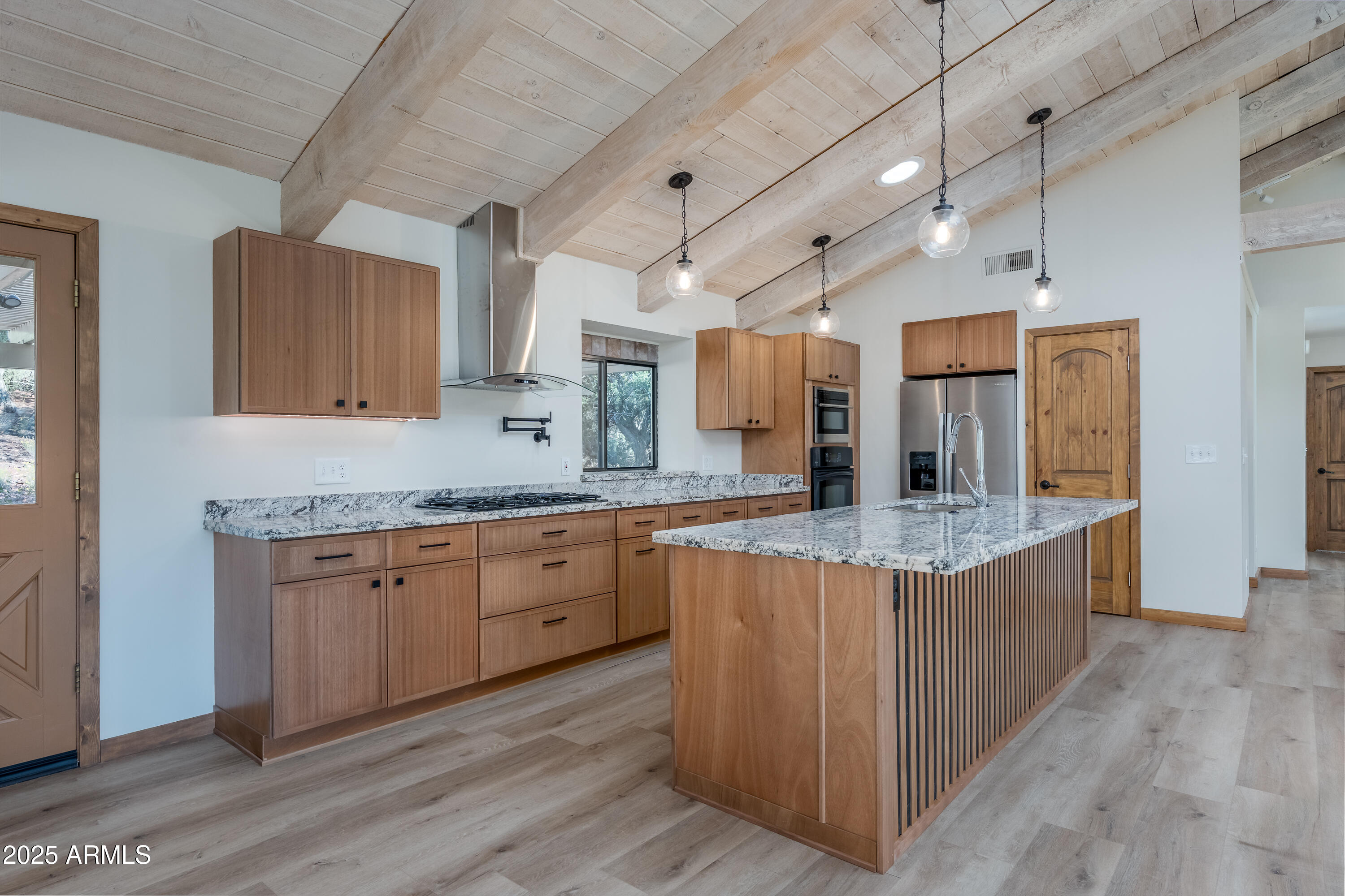 1050 Lee Mountain Road Sedona, AZ 86351 - Photo 67 of 80 a large kitchen with granite countertop a sink and dishwasher a oven with wooden cabinets
