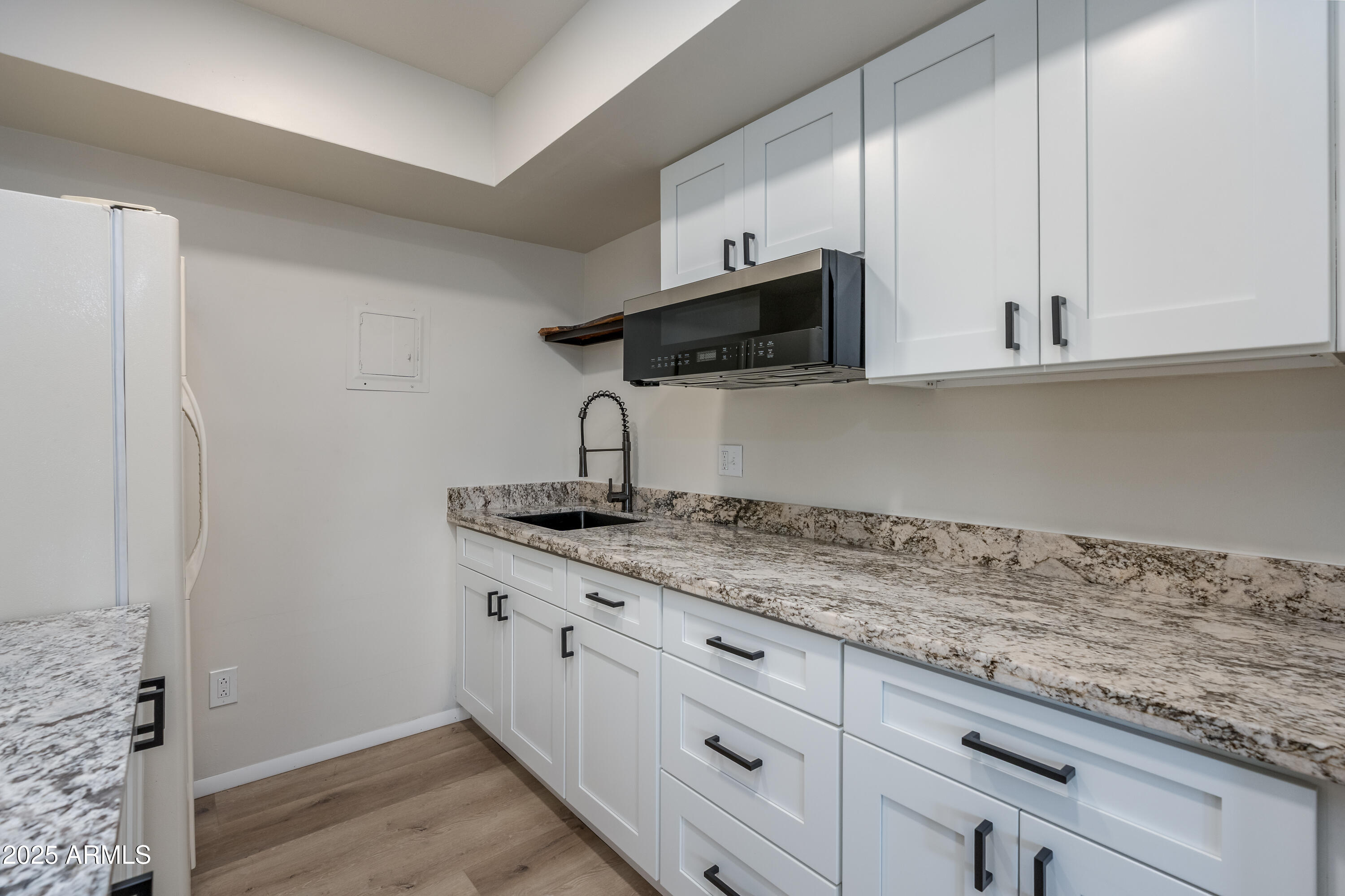 1050 Lee Mountain Road Sedona, AZ 86351 - Photo 77 of 80 a kitchen with a sink and cabinets