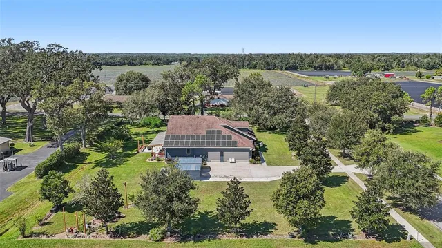 a front view of a house with a yard patio and green space
