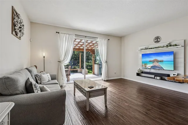 a view of a livingroom and dining room with wooden floor