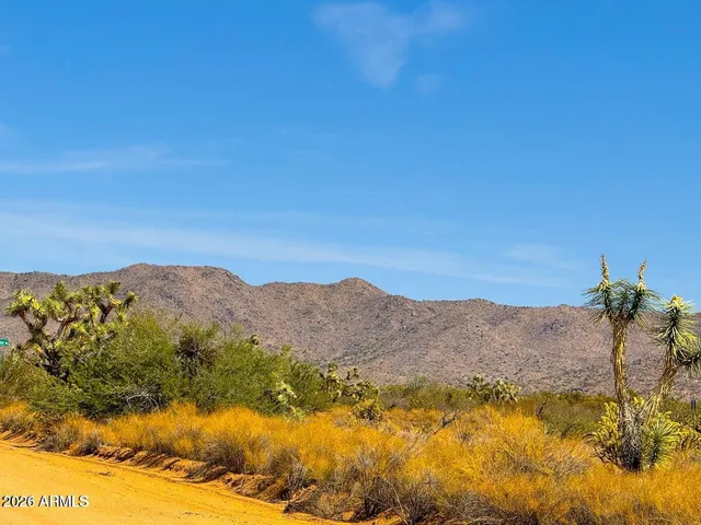 a view of a mountain range in a cloudy sky