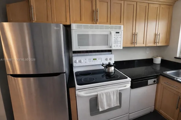 a kitchen with refrigerator and cabinets