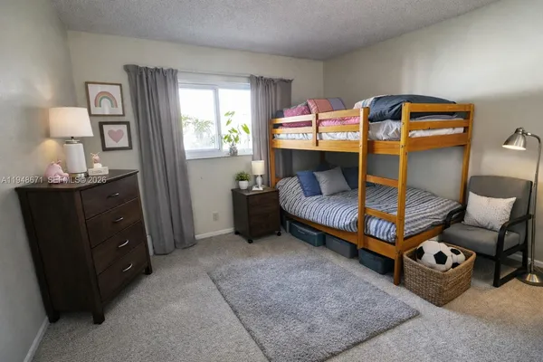 a bedroom with bed and window