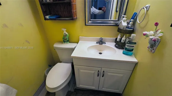 a bathroom with a sink mirror and toilet