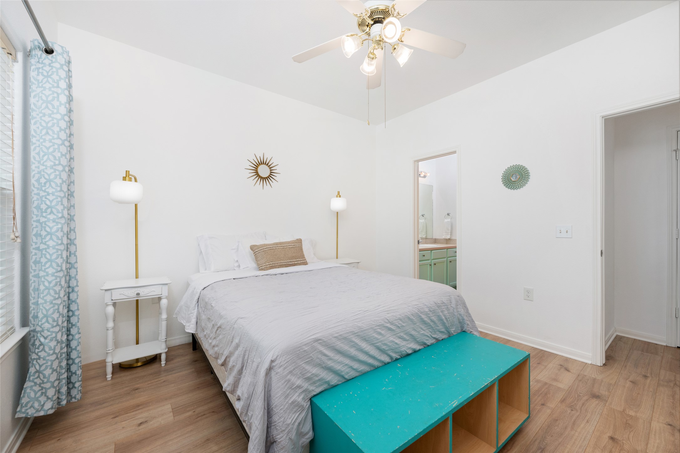 5613 Signal Point Austin, TX 78724 - Photo 14 of 21 Bedroom featuring wood-finish flooring, a ceiling fan with integrated lighting, and a window with blinds and patterned drapes