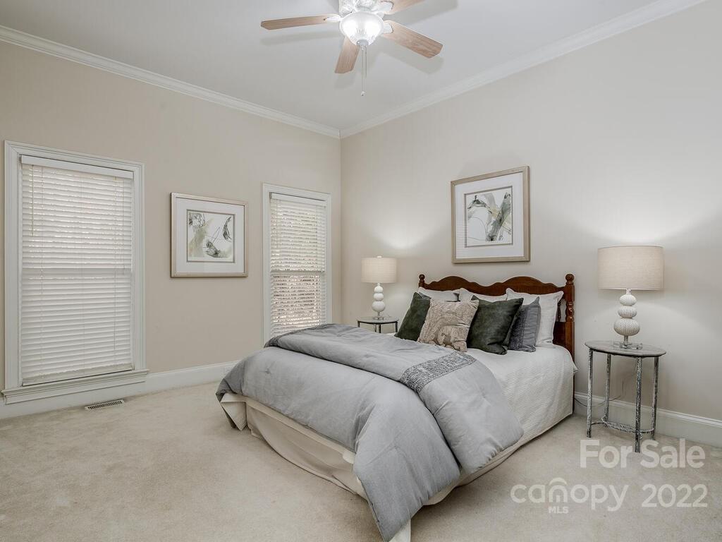4101 High Ridge Road Charlotte, NC 28270 - Photo 14 of 38 a bedroom with bed and a chandelier