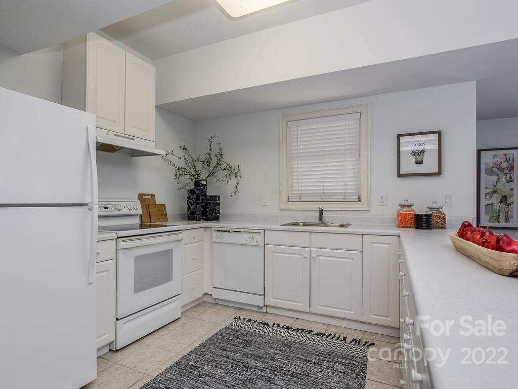 4101 High Ridge Road Charlotte, NC 28270 - Photo 28 of 38 a kitchen with granite countertop white cabinets and white appliances