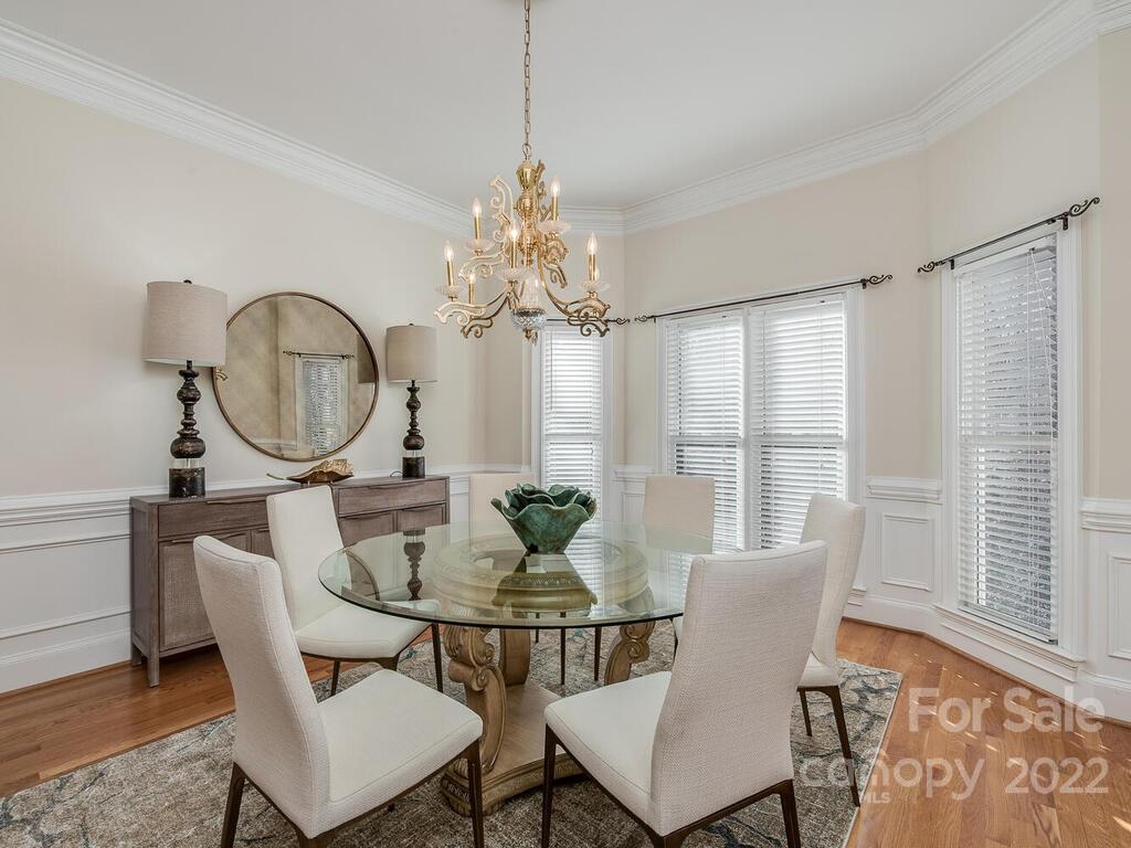 4101 High Ridge Road Charlotte, NC 28270 - Photo 5 of 38 a dining room with furniture a chandelier and wooden floor