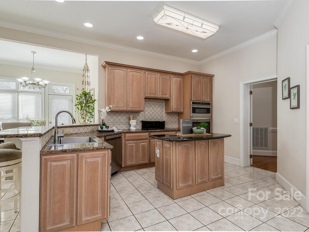 4101 High Ridge Road Charlotte, NC 28270 - Photo 6 of 38 a kitchen with stainless steel appliances granite countertop a stove a sink and a refrigerator