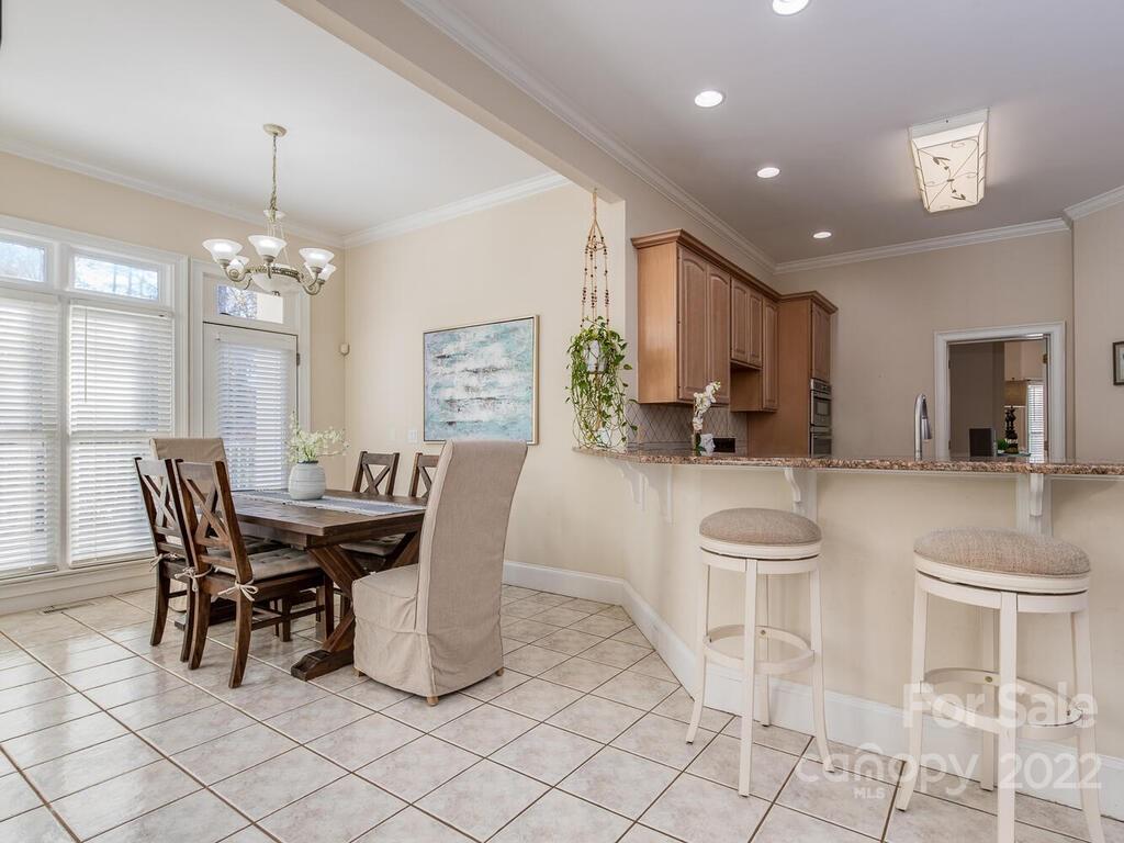 4101 High Ridge Road Charlotte, NC 28270 - Photo 8 of 38 a dining room with furniture and a chandelier