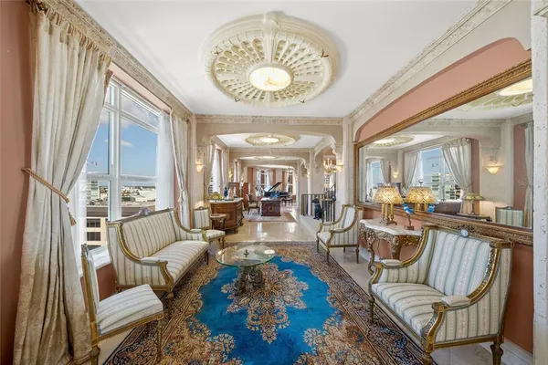 a living room with furniture and a chandelier