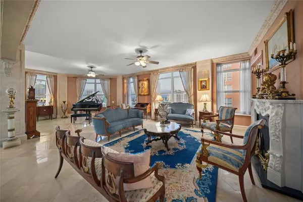 a living room with furniture a flat screen tv and a table