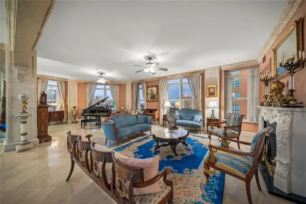 a living room with stainless steel appliances granite countertop a stove and a refrigerator