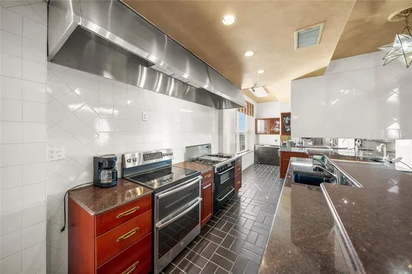 a spacious bathroom with a granite countertop sink and a mirror