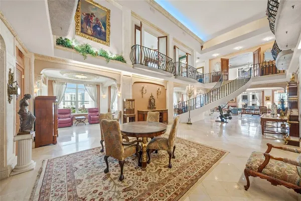 a living room with fireplace furniture and a rug