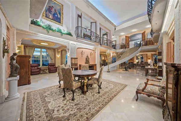 a living room with furniture a rug and a window
