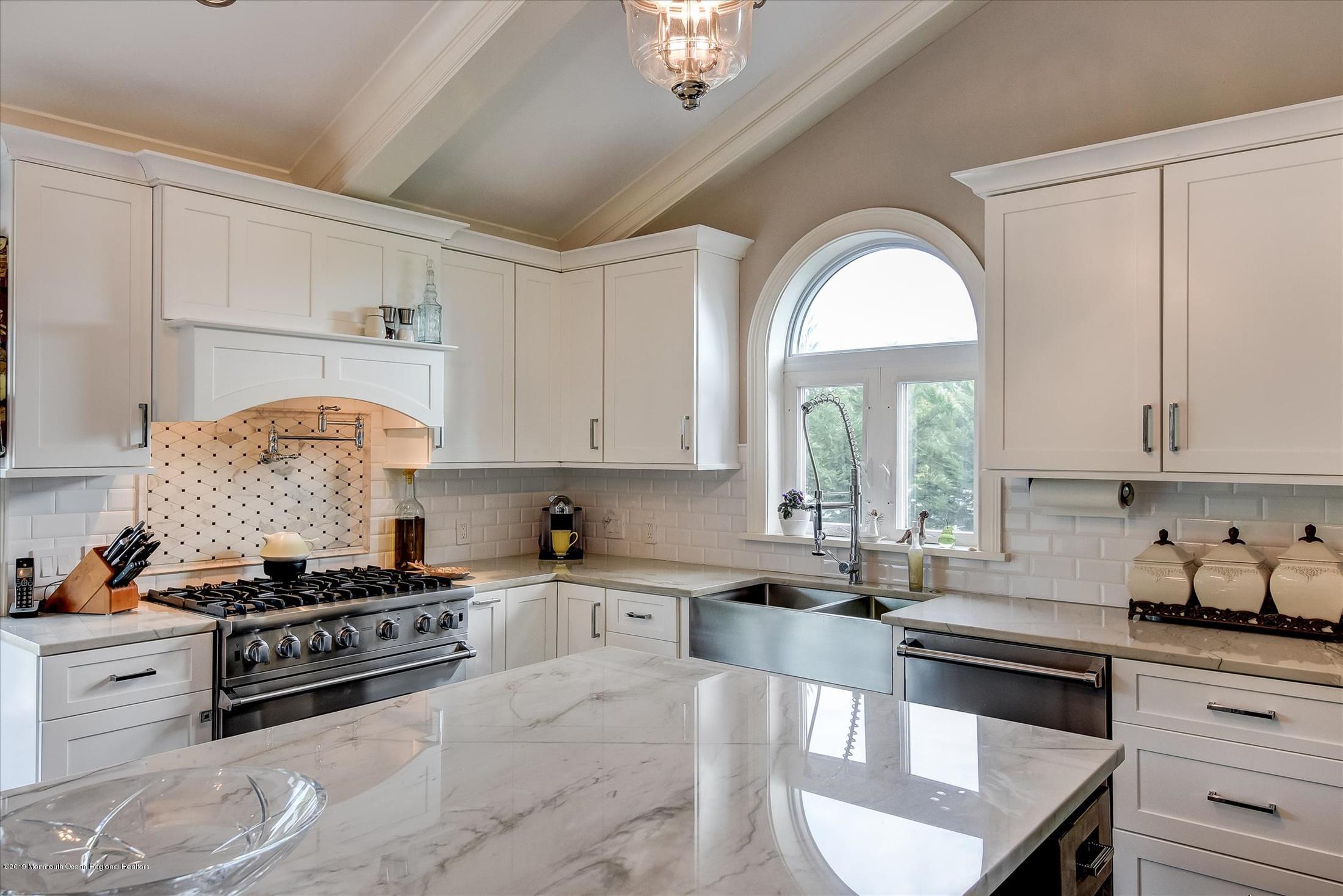 244 Elton Adelphia Road Freehold, NJ 07728 - Photo 13 of 46 a kitchen with stainless steel appliances granite countertop a stove a sink and a white cabinets