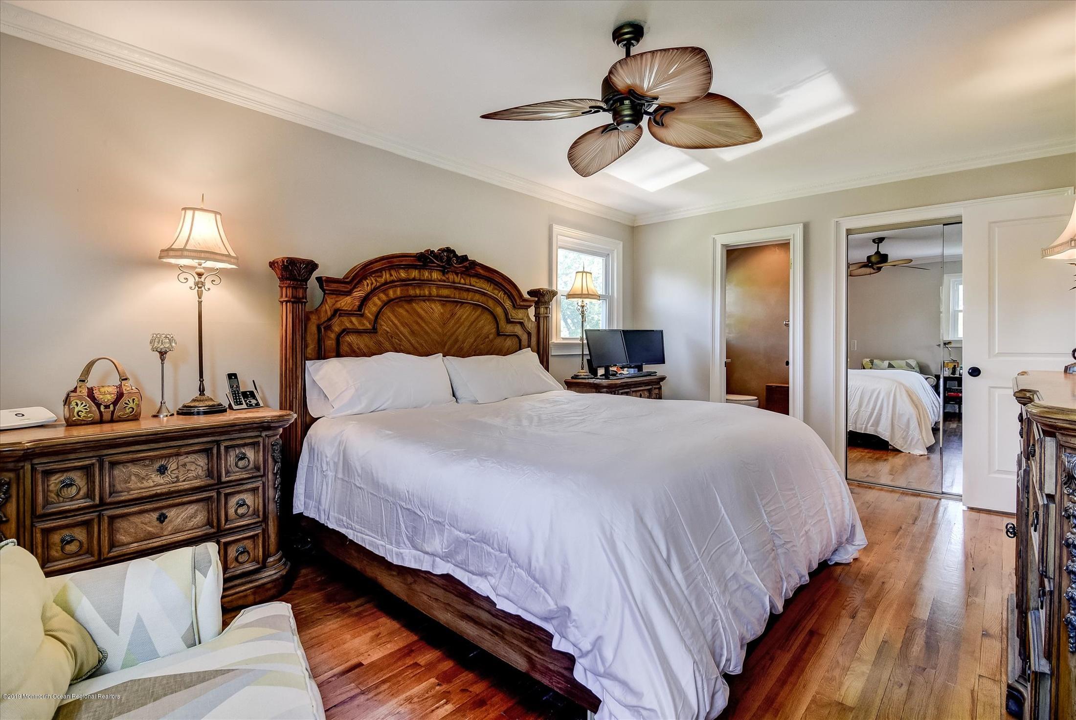 244 Elton Adelphia Road Freehold, NJ 07728 - Photo 18 of 46 a bedroom with a bed and wooden floor