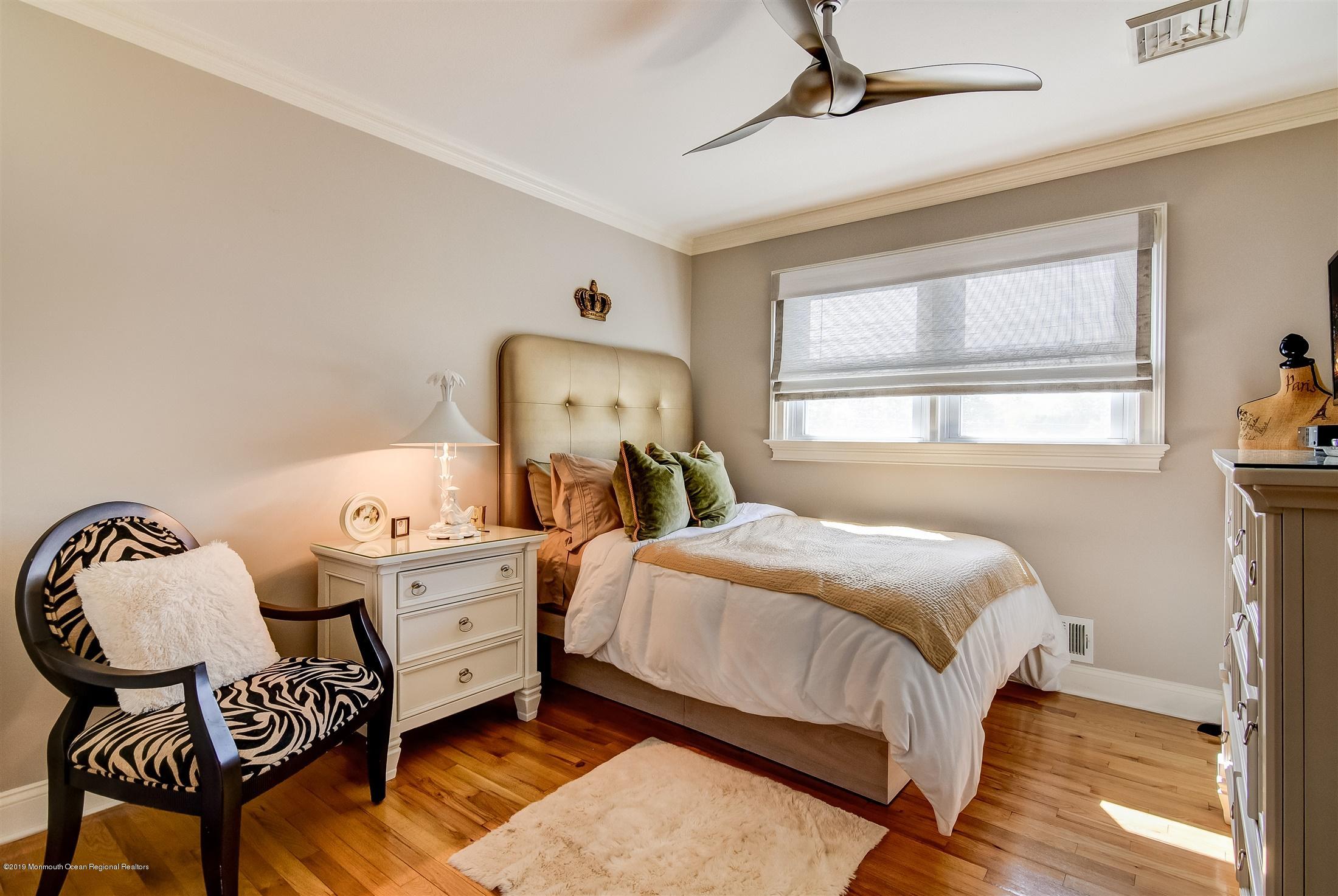 244 Elton Adelphia Road Freehold, NJ 07728 - Photo 21 of 46 a bedroom with a bed and wooden floor