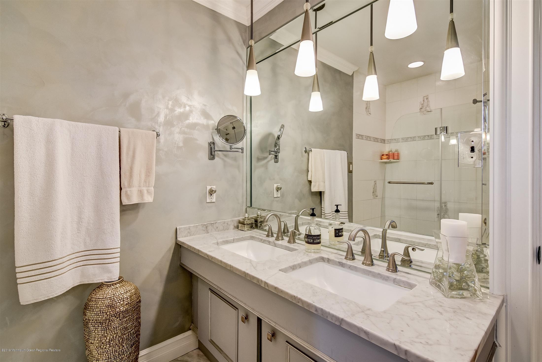 244 Elton Adelphia Road Freehold, NJ 07728 - Photo 24 of 46 a bathroom with double vanity and a mirror